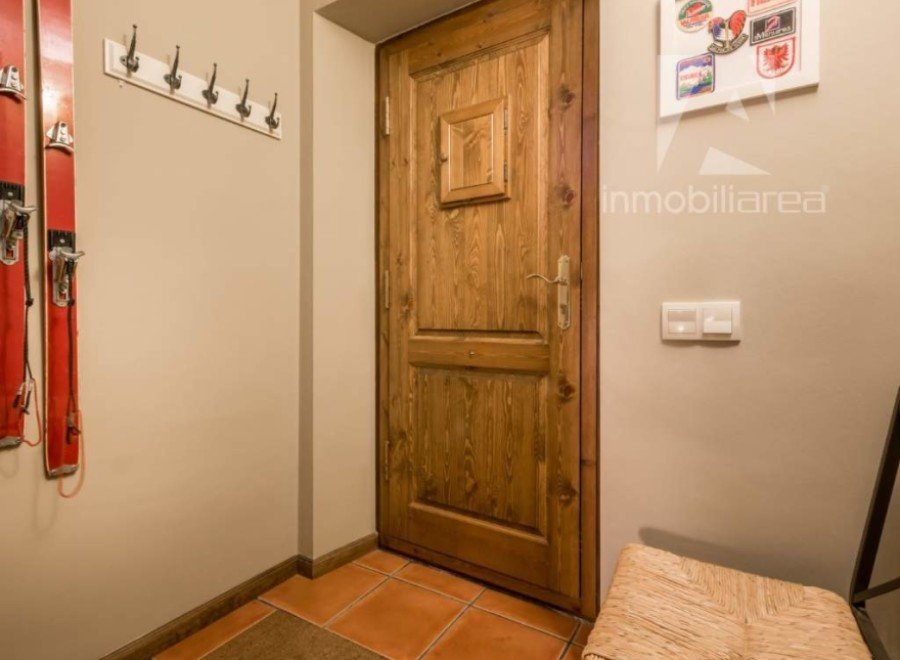 Discover a charming entryway featuring a rustic wooden door and warm, inviting tones.