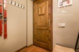 Discover a charming entryway featuring a rustic wooden door and warm, inviting tones.