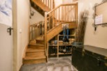 This charming property features a beautiful wooden staircase, adding warmth and character to the space.