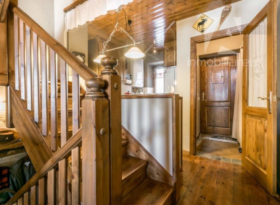This charming property features a beautifully crafted wooden staircase, adding warmth and character to the interior.