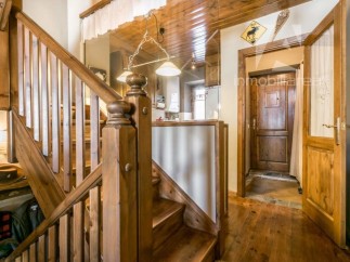 This charming property features a beautifully crafted wooden staircase, adding warmth and character to the interior.