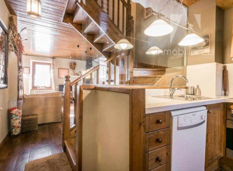 Discover the charm of this rustic property, featuring a beautifully crafted wooden staircase that adds character and warmth.