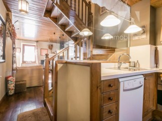 Discover the charm of this rustic property, featuring a beautifully crafted wooden staircase that adds character and warmth.