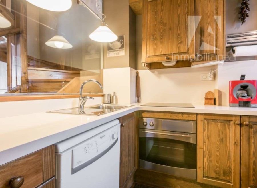 Discover the charm of this beautifully designed kitchen, featuring rustic wooden cabinetry and modern appliances.