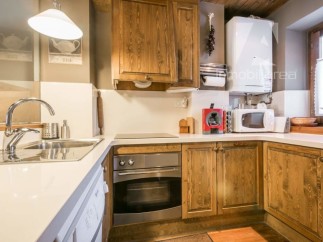 Discover a charming kitchen with rustic wooden cabinets and a modern touch.