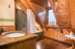 This charming bathroom features a unique wooden design, creating a warm and inviting atmosphere.