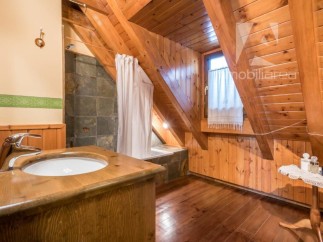 This charming bathroom features a unique wooden design, creating a warm and inviting atmosphere.