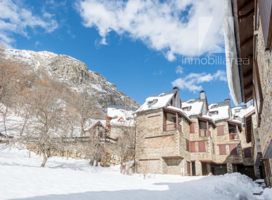 Discover a charming mountain retreat nestled in a snowy landscape.