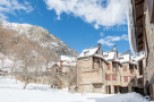 Discover a charming mountain retreat nestled in a snowy landscape.