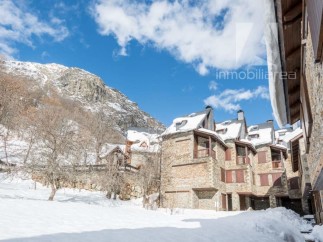 Discover a charming mountain retreat nestled in a snowy landscape.