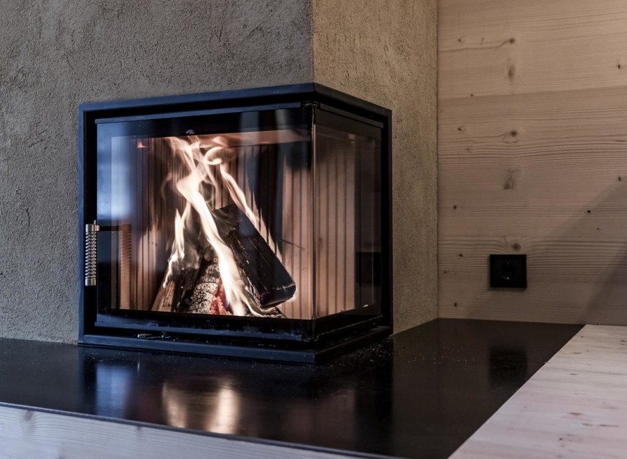 Cozy up in front of this stunning fireplace! This property boasts a modern, sleek design with a beautiful black countertop.