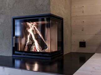 Cozy up in front of this stunning fireplace! This property boasts a modern, sleek design with a beautiful black countertop.
