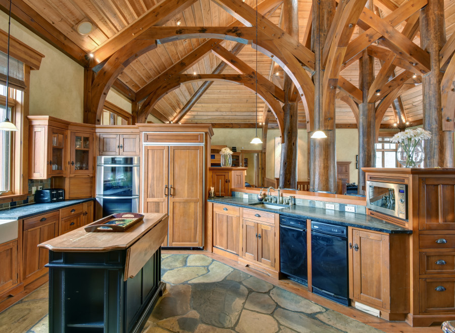 This stunning kitchen boasts a rustic, yet elegant design with exposed wooden beams and cabinetry.