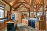 This stunning kitchen boasts a rustic, yet elegant design with exposed wooden beams and cabinetry.