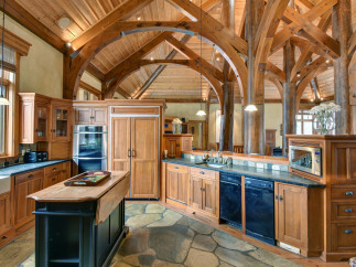 This stunning kitchen boasts a rustic, yet elegant design with exposed wooden beams and cabinetry.