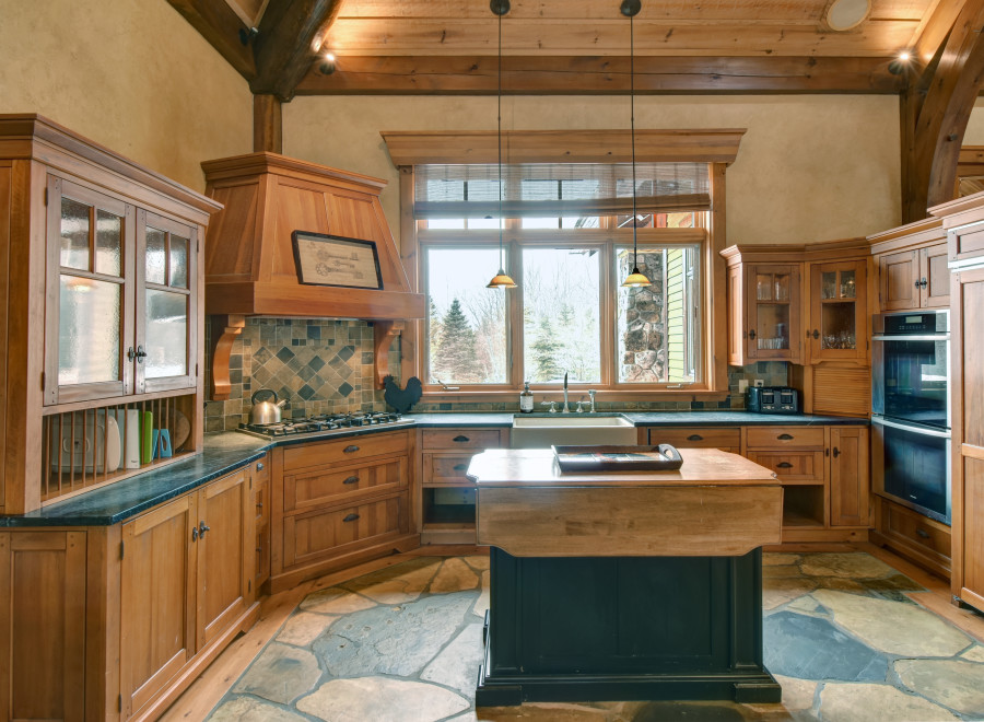 This stunning kitchen boasts custom wooden cabinetry, creating a warm and inviting atmosphere.