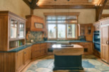 This stunning kitchen boasts custom wooden cabinetry, creating a warm and inviting atmosphere.