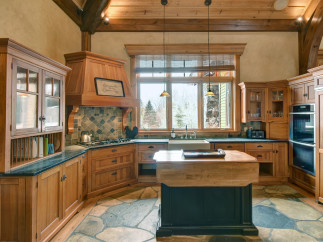 This stunning kitchen boasts custom wooden cabinetry, creating a warm and inviting atmosphere.
