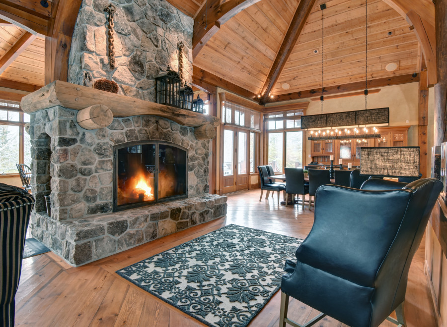 Experience rustic elegance in this stunning home featuring a grand stone fireplace, perfect for cozy evenings.