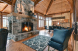 Experience rustic elegance in this stunning home featuring a grand stone fireplace, perfect for cozy evenings.