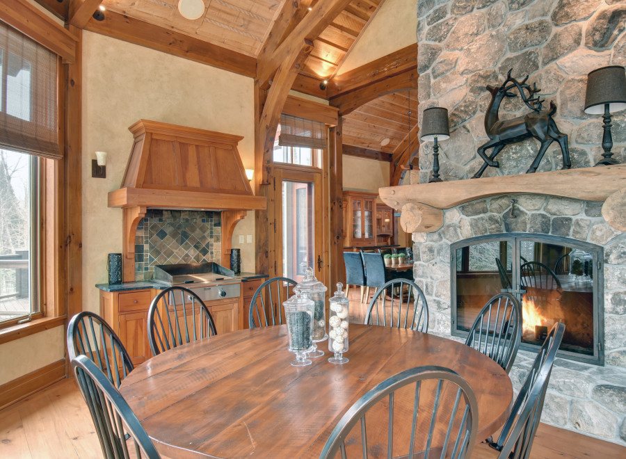 This stunning property boasts a rustic charm with its exposed wooden beams and stone fireplace.