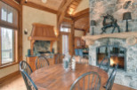 This stunning property boasts a rustic charm with its exposed wooden beams and stone fireplace.