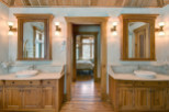 This luxurious bathroom features custom wooden cabinetry and a stunning marble countertop, creating a warm and inviting atmosphere.