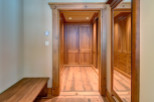 Step into luxury with this stunning walk-in closet, featuring custom wooden cabinetry and ample storage space.