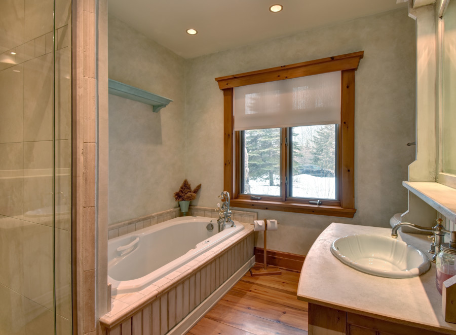 This luxurious bathroom features a stunning soaking tub, perfect for unwinding after a long day.