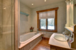 This luxurious bathroom features a stunning soaking tub, perfect for unwinding after a long day.