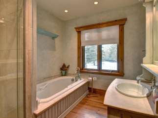 This luxurious bathroom features a stunning soaking tub, perfect for unwinding after a long day.