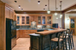 This stunning kitchen boasts custom wooden cabinetry and a spacious layout, perfect for both cooking and entertaining.