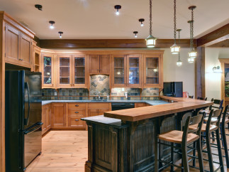 This stunning kitchen boasts custom wooden cabinetry and a spacious layout, perfect for both cooking and entertaining.