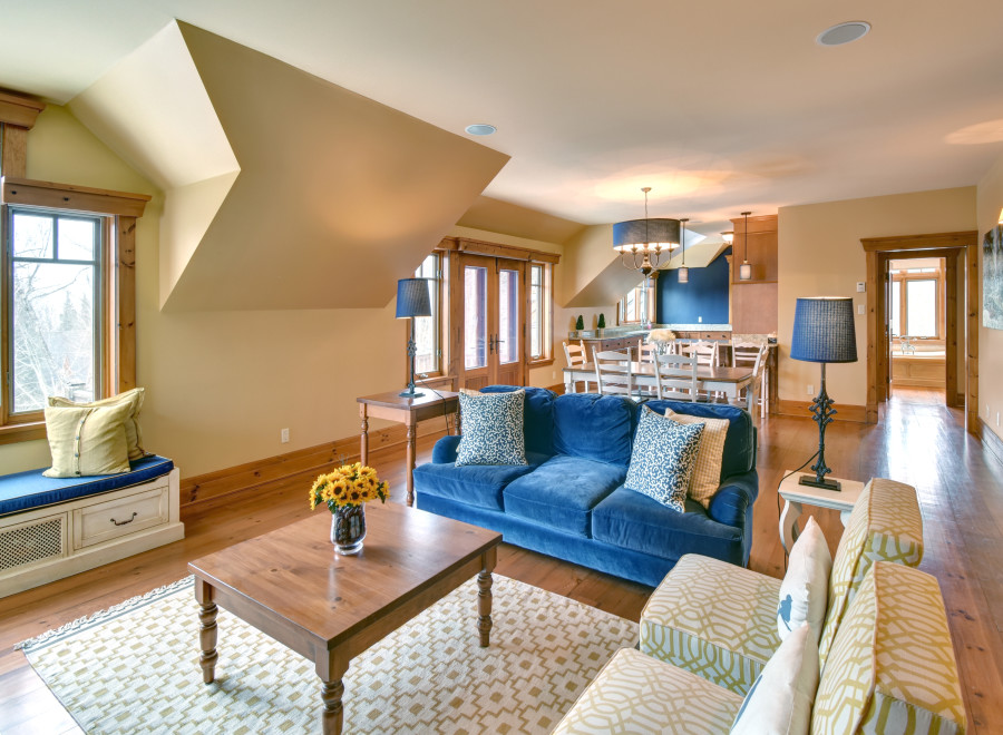 This stunning living space boasts a cozy ambiance with its plush blue sofa and inviting seating arrangement.