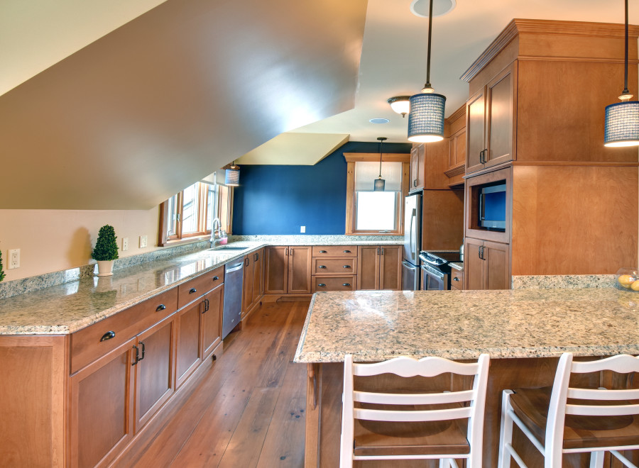 This stunning kitchen boasts custom cabinetry and granite countertops, creating a warm and inviting atmosphere.