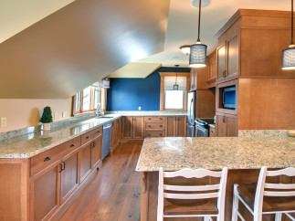 This stunning kitchen boasts custom cabinetry and granite countertops, creating a warm and inviting atmosphere.