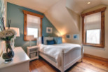 This charming bedroom features a cozy ambiance with its inviting decor and natural light.