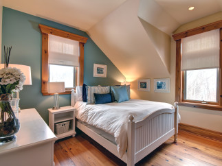 This charming bedroom features a cozy ambiance with its inviting decor and natural light.