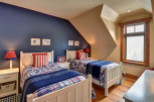 This cozy bedroom features two twin beds, perfect for a guest room or kids' space.