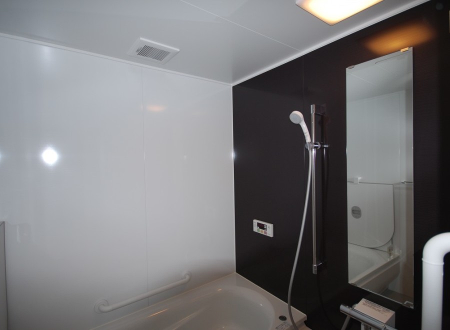 This modern bathroom features a sleek design with contrasting black and white walls.