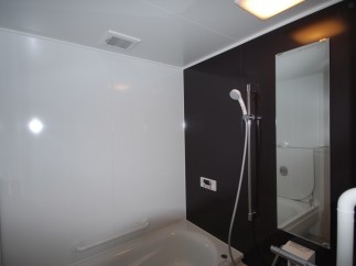 This modern bathroom features a sleek design with contrasting black and white walls.
