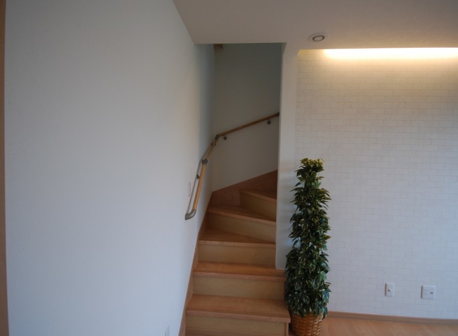Discover a beautifully designed interior with a charming staircase leading to the upper levels.