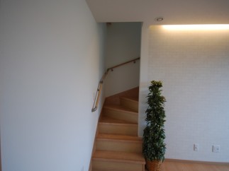 Discover a beautifully designed interior with a charming staircase leading to the upper levels.