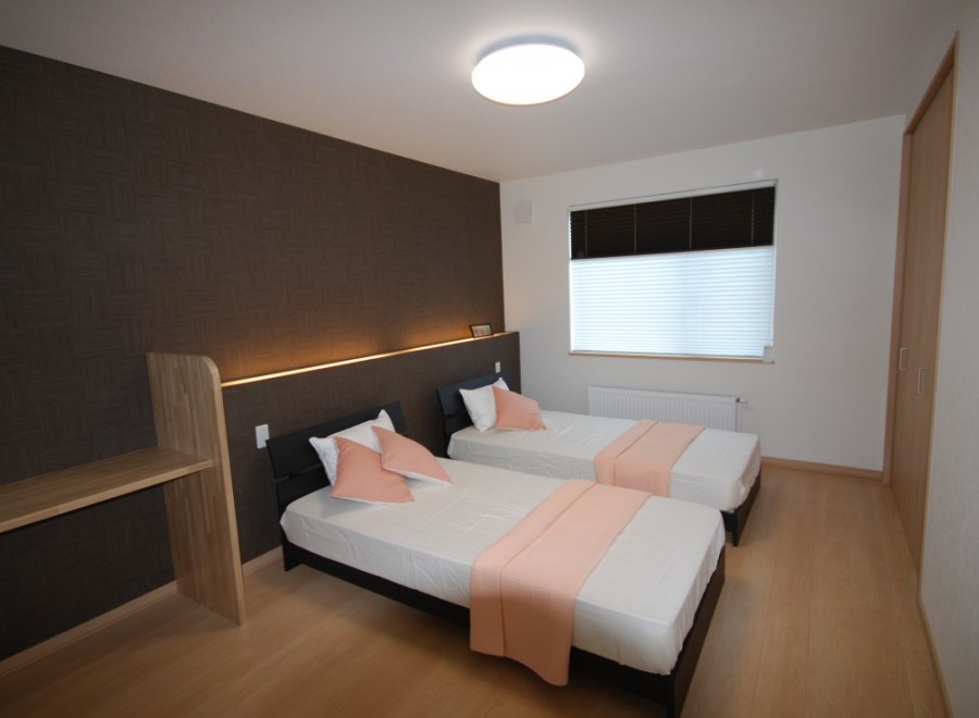 This cozy bedroom features two comfortable beds, perfect for guests or roommates.
