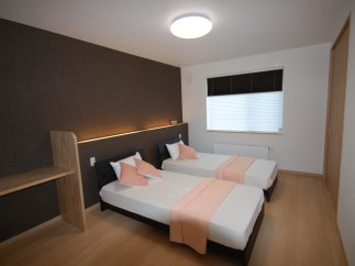This cozy bedroom features two comfortable beds, perfect for guests or roommates.
