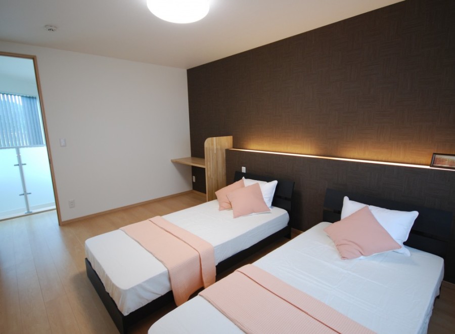 Discover a cozy bedroom with two comfortable beds, perfect for a relaxing stay.