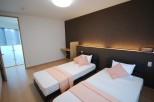 Discover a cozy bedroom with two comfortable beds, perfect for a relaxing stay.