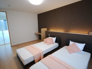 Discover a cozy bedroom with two comfortable beds, perfect for a relaxing stay.