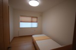 Cozy bedroom with natural light and a comfortable bed.