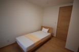 Cozy and inviting bedroom featuring a comfortable single bed.